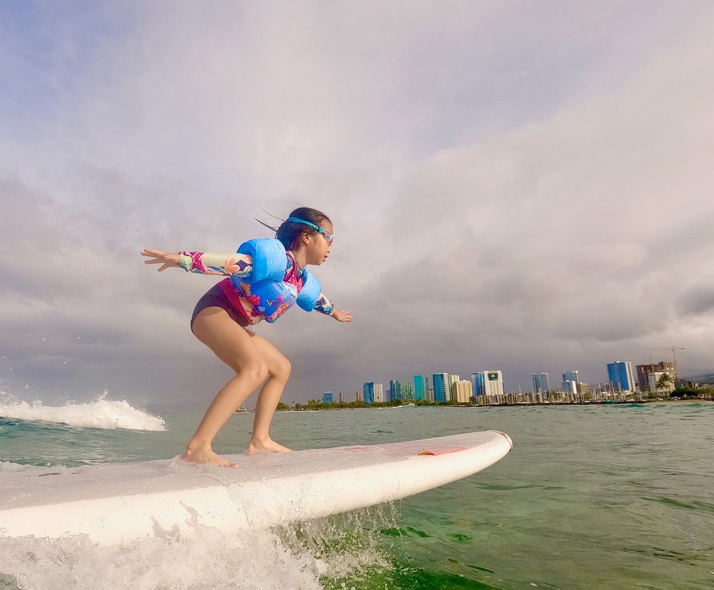 Young girl surfing in Hawaii